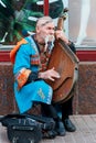 An Kobzar singing to his own accompaniment on bandura instrument on Khreshchatyk street in Kiev, Ukraine.