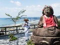 Jizo statue and walking pilgrim on the grounds of Zenjibuji, temple number 32 of Shikoku pilgrimage