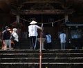 O-henro pilgrim climbing the stairs leading to the main hall of Kiyotakiji, temple number 35 of