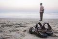 Sandals Source and man on the sand beach at sunset