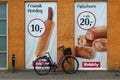 Hot dogs adverts and parked bike. Royalty Free Stock Photo