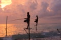 Silhouettes of the traditional Sri Lankan stilt fishermen on a stormy in Koggala, Sri Lanka. Stilt fishing is a method of fishing