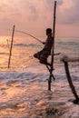 Silhouettes of the traditional Sri Lankan stilt fishermen on a stormy in Koggala, Sri Lanka. Stilt fishing is a method of fishing