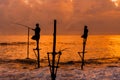 Silhouettes of the traditional Sri Lankan stilt fishermen on a stormy in Koggala, Sri Lanka. Stilt fishing is a method of fishing