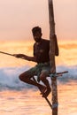 Silhouettes of the traditional Sri Lankan stilt fishermen on a stormy in Koggala, Sri Lanka. Stilt fishing is a method of fishing