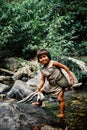 kogi tribal kid doing laundry in the nearby stream close to their home