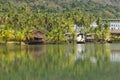 Marsh and palm tree landscape with abandoned tourist bungalows