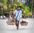 Koh Chang, THAILAND - MARCH 12: An elderly woman sells to tourists souvenirs on the beach, Thailand, on March 12, 2015.