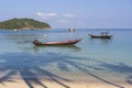 Beautiful bay with palm trees and boats. Tropical beach and sea water on the island Koh Phangan, Thailand Royalty Free Stock Photo