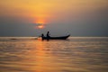 Silhouette of thai man in a boat during sunset at sea water near tropical island Koh Phangan, Thailand Royalty Free Stock Photo