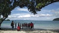 Vacationers take a group selfie on the shore of the magnificent sea on a tropical island