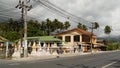 KOH SAMUI ISLAND, THAILAND - 24 JUNE 2019 Deserted road with spirit houses in Thai style. Typical countryside road with shop of