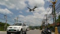 KOH SAMUI ISLAND, THAILAND - 23 JUNE 2019 Plane landing over typical main road street of tropical town. Aircraft flying to Bangkok