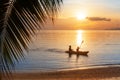 Sea sunset, ocean sunrise, tropical island beach, palm tree leaves, blue water wave, two people silhouette in boat, kayak, canoe Royalty Free Stock Photo