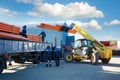 Kohonovo, Belarus - 29 October, 2017: truck and people loads stacks of black pvc plastic pipe outdoors outside the warehouse