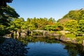 Koko-en traditional japanese garden with a pond reflecting trees, Himeji, Japan