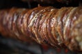 Kokorech, lamb intestines and giblets are cooked on spit, bokeh selective focus