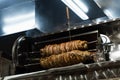 Kokorech lamb intestines roasting in Turkish market. Traditional street food.