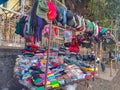 Stock photo of colorful woolen caps, regular caps, hat, socks and hand gloves hanging at street shop or stall during winter month