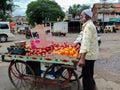 Stock photo of 50 to 60 year old Indian fruit seller selling fresh fruits like apple , orange etc Royalty Free Stock Photo