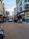 the cityscape came alive with a vibrant blend of people walking on the roads, vehicles moving.