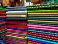 In the cloth merchant shop, there is showcasing a multitude of colorful, designer Indian-style