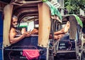 Kolkata, India - August 28, 2019: Rickshaw puller resting on his rickshaw on street of kolkata