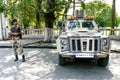 Kolkata, India - August 29, 2020 : young indian soldier guard holding light machine gun and marksman armoured vehicle are observed