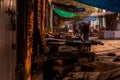 Kolkata, India - 12 December, 2021: Street market with people walking and shops closed with polythene wrapped over and held by Royalty Free Stock Photo