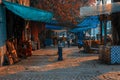 Kolkata, India - 12 December, 2021: A street market with people walking on the street and shops open on the left Royalty Free Stock Photo