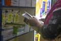 Kolkata, India- 29January, 2020 A woman is checking out collection of different books in different shop in International bookfair