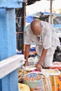 Kolkata, India-July 27,2019: Shopkeeper selling goods at Patuli Floating Market, Kolkata, India