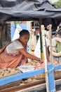 Kolkata, India-July 27,2019: Shopkeeper selling goods at Patuli Floating Market, Kolkata, India