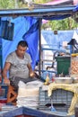 Kolkata, India-July 27,2019: Shopkeeper selling goods at Patuli Floating Market, Kolkata, India