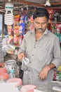 Kolkata, India-July 27,2019: Shopkeeper selling goods at Patuli Floating Market, Kolkata, India