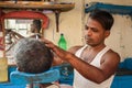 Indian barber shaving man on the street in Kolkata. India
