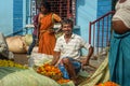 Indian seller weighs flowers by scales on Flower market at Mallick Ghat in Kolkata. India Royalty Free Stock Photo