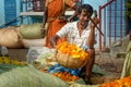 Indian seller weighs flowers by scales on Flower market at Mallick Ghat in Kolkata. India