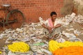 Indian trader near wall on Flower market at Mallick Ghat in Kolkata. India