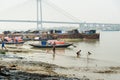 Traditional wooden fishing boats in river Hooghly or Ganga near Vidyasagar bridge. Kolkata. India