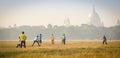 BOYS PLAYING CRICKET I A WINTER MORNING AT MAIDAN Royalty Free Stock Photo