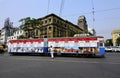 A colorfully decorated tram in the city street of Kolkata. Royalty Free Stock Photo