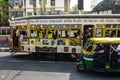 A colorfully decorated tram in the city street of Kolkata.