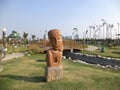 Kolkata, West Bengal/India - February 18, 2014: Tribal wooden decorated statue on green field or park openly for public at `Eco Pa