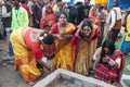 The Hindu devotees are busy in a holy ritual in front of a Homa Kund.