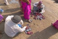 Seller selling shoes to sari clad Indian women, Kolkata, India