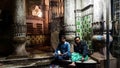 Workers sitting in a dark corner of the vintage architecture of the historic Mullick