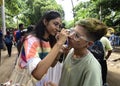 The LGBT activists painted over the cheek with rainbow flag.