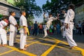 KOLKATA, WEST BENGAL, INDIA - MARCH 21ST 2015 : Young boy in white dress jumping off ground to kick, karate practice at