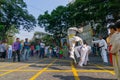 KOLKATA, WEST BENGAL, INDIA - MARCH 21ST 2015 : Young boy in white dress jumping off ground to past two fellow boys over, karate